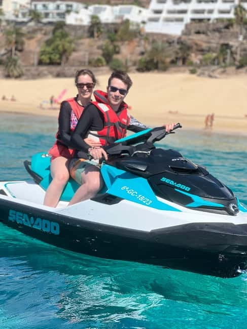 From Morro Jable: Jet Ski Adventure Tour (without license) - What you see out there: Morro Jable coastline, clear water, and flying fish