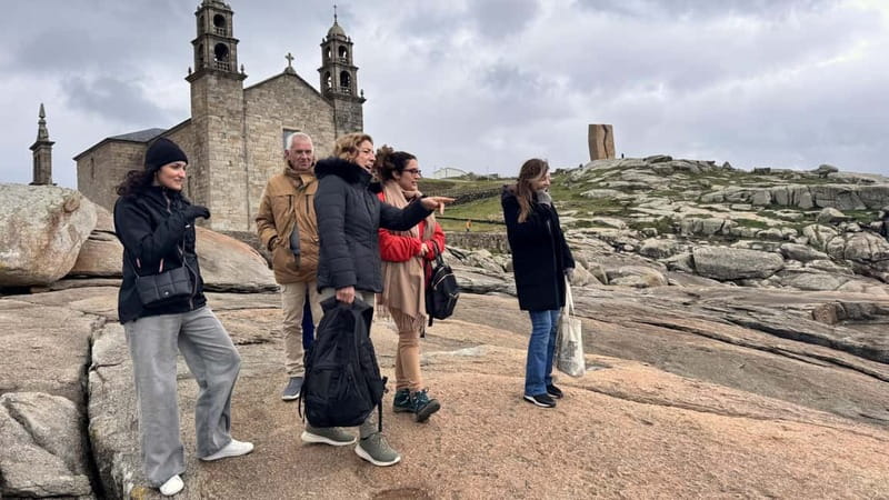 From Santiago: Finisterre, Muxía & Costa da Morte Tour - Finisterre lighthouse and the Fisterra harbor, where lunch becomes part of the story