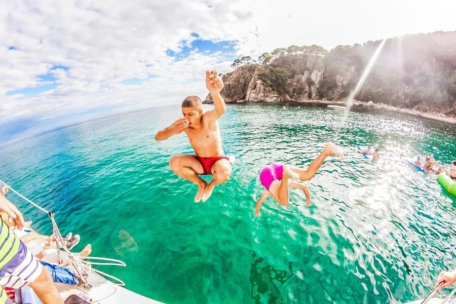 Lloret de Mar: Catamaran Sailing Cruise with BBQ and Drinks - The sailing hour past cliffs and caves, what the first stretch feels like