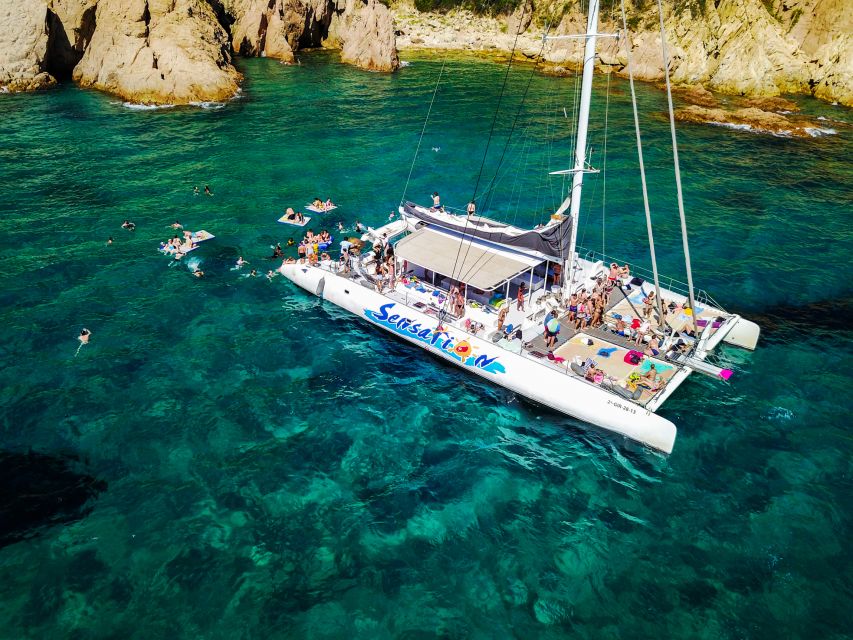 Lloret de Mar: Catamaran Sailing Cruise with BBQ and Drinks - The anchor stop is the main event: trampoline, floating time, snorkeling