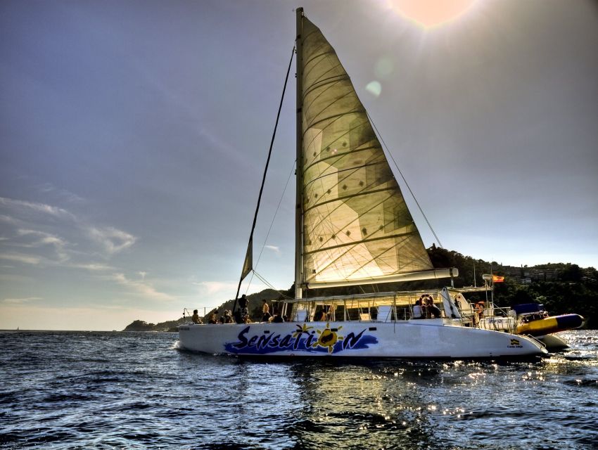Lloret de Mar: Sunset Catamaran Cruise with DJ and Drinks - The onboard vibe: DJ music, drinks, and a true party tempo
