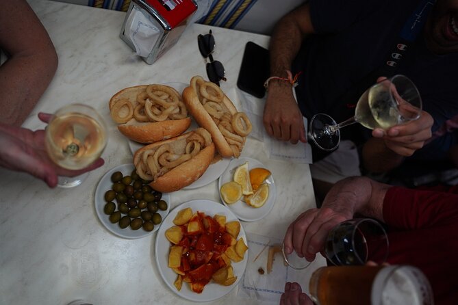 Madrid by Night: Tapas Crawl, Local Drinks & Hidden Gems - La Latina at night: tiny tables and classic tapas energy