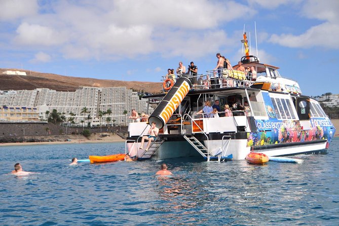 Odyssee 3: The Glass Bottom Boat Tour in Fuerteventura - The water-play stop: slide, swim, snorkeling, kayak, and paddle surf