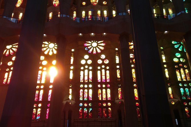 Sagrada Familia Guided Tour with Towers Access - Inside the basilica: stained-glass light, columns, and the altar