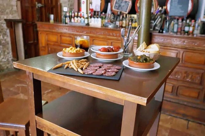 Sevilla Food Tour: Tapas, Wine, History & Traditions - Barrio Santa Cruz: a family-run patio tavern with albóndigas, pestiños, and PX